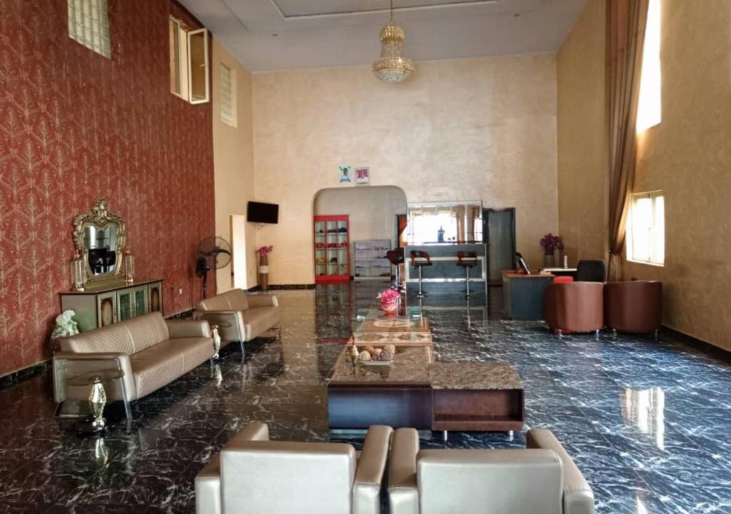 Hotel lounge with chandelier, seating, and marble floors