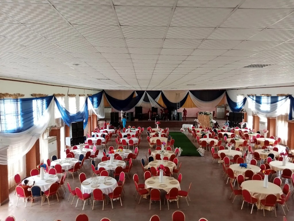 Event hall set for a reception with round tables and stage